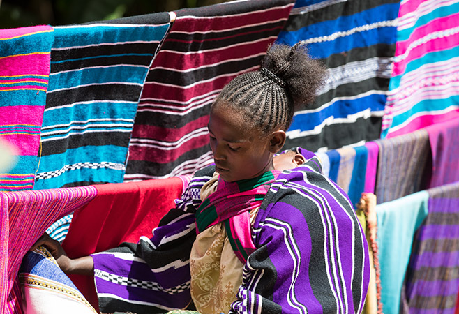 Handwoven textiles and scarves for sale at a Dorze community market
